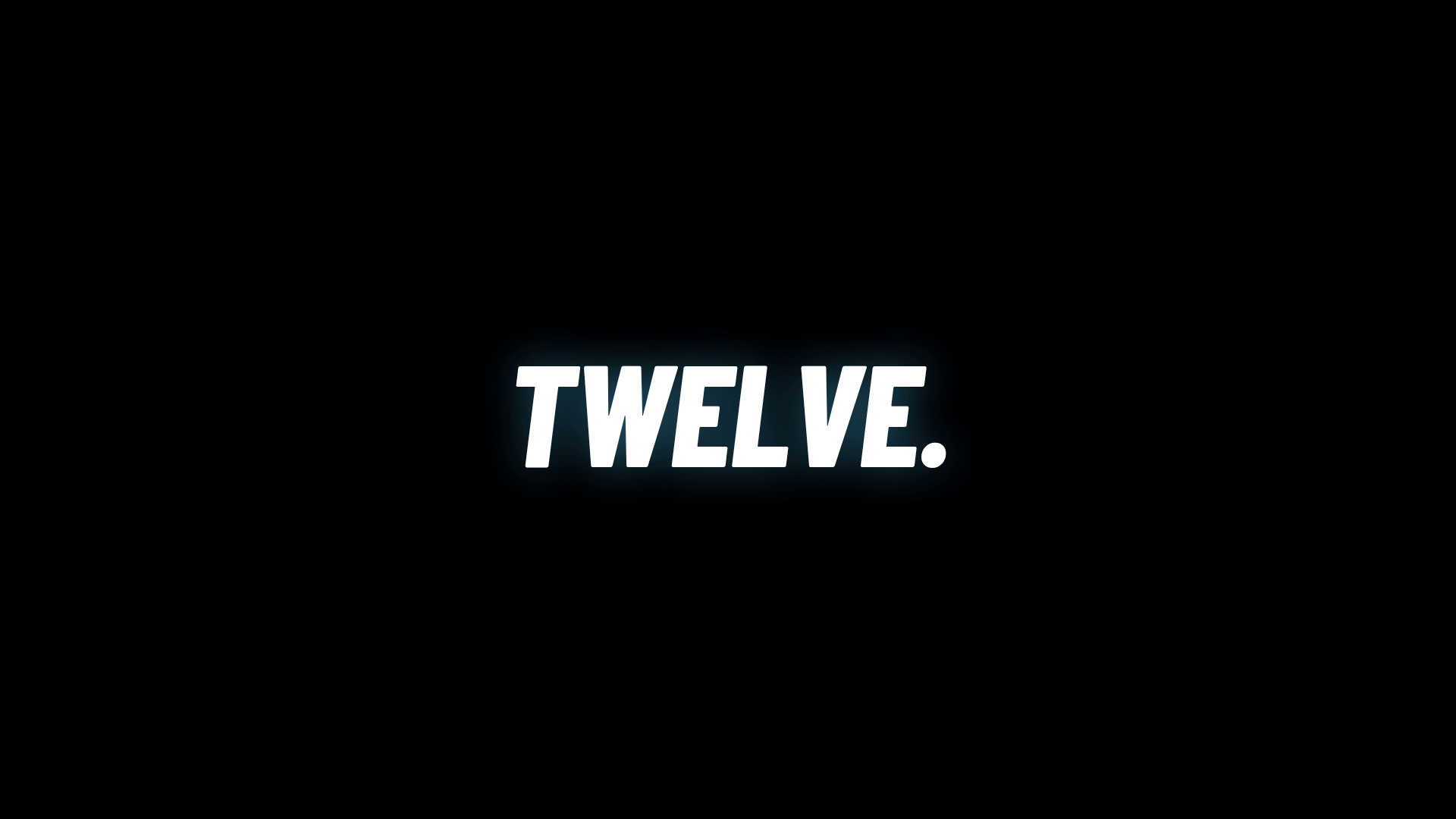 A frame of the film: the word TWELVE alone on black, stamped on a hit of the bed.